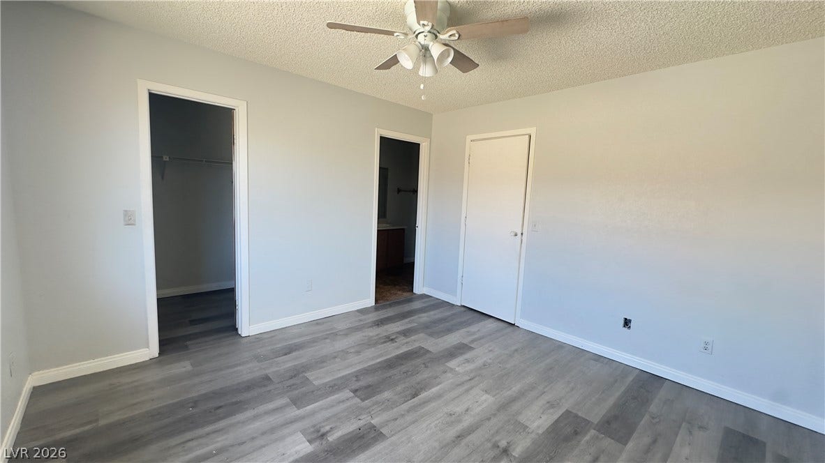 543 KRISTIN Lane, Henderson, NV 89011 Smooth wood-plank flooring runs throughout this bedroom featuring private closet and bathroom access.