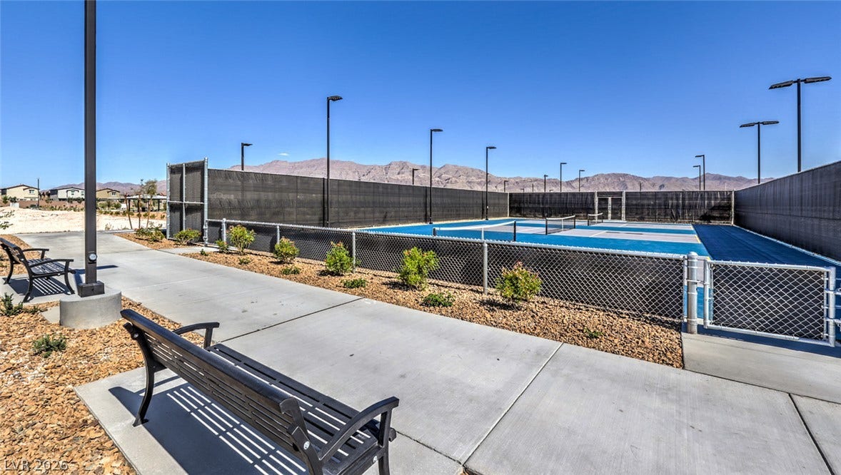 Well-maintained community pickleball courts offer recreation against a backdrop of distant mountains.