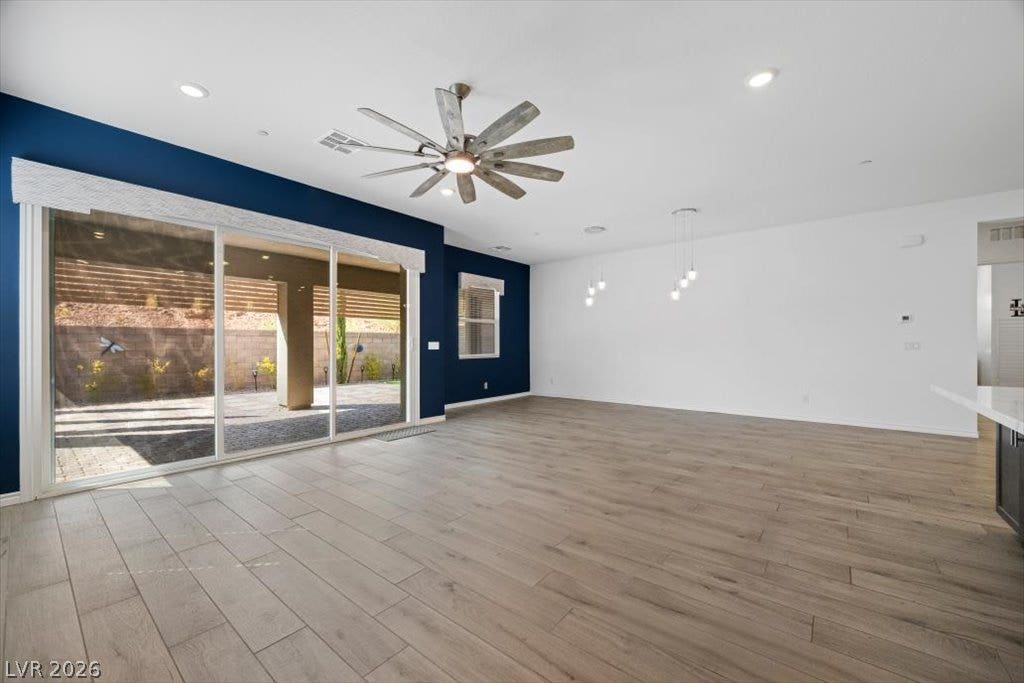 Sliding glass doors open from the living and dining area and opening to a covered backyard patio.