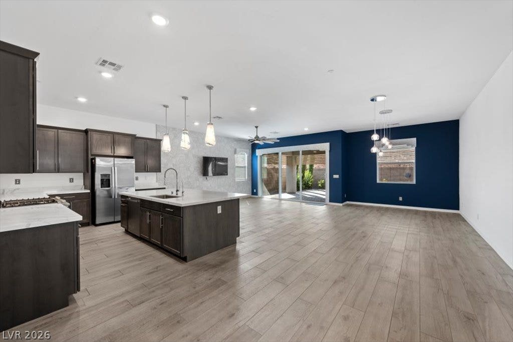 An open floorplan seamlessly connects the modern kitchen and dining area to the backyard.