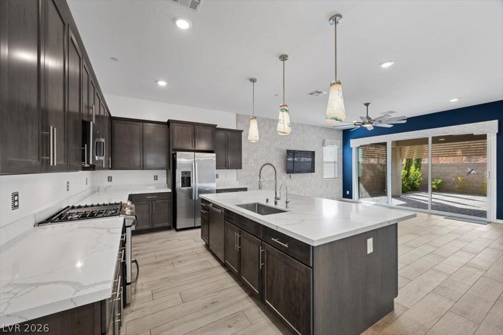 An open kitchen layout flows seamlessly into the living space with sliding glass doors for back yard access