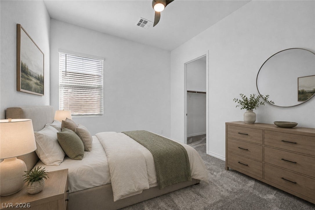 A spacious bedroom features plush carpeting and a large walk-in closet and direct access to bath virtually staged