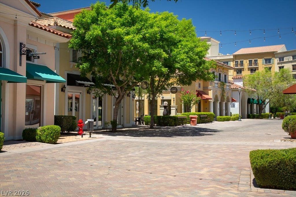 Mediterranean-inspired walkways are lined with mature trees, manicured hedges, and charming storefronts.