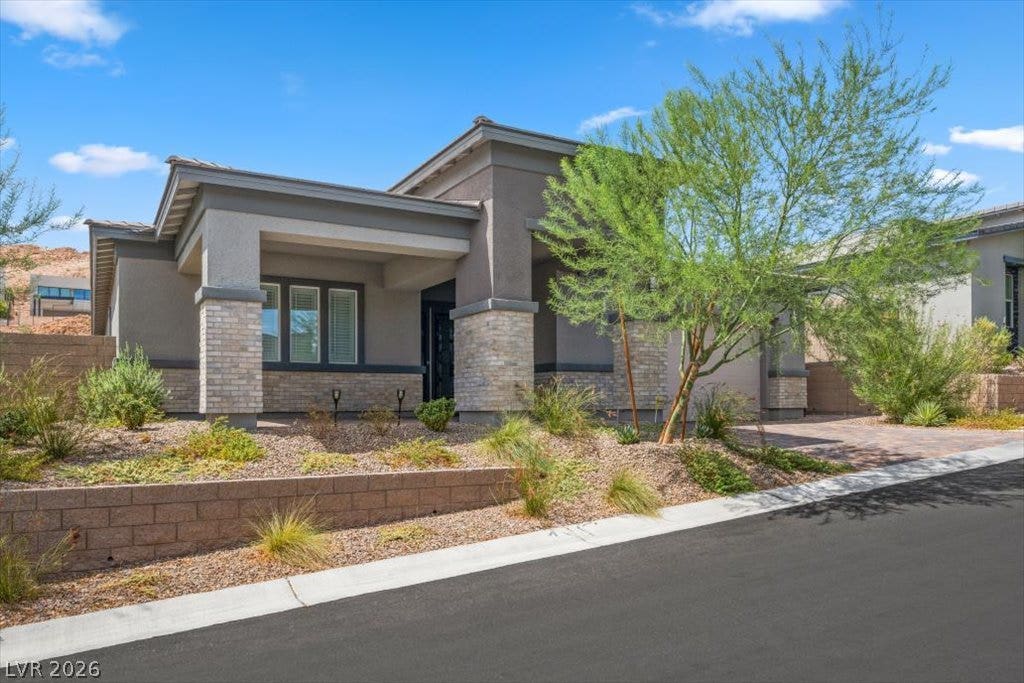 Striking contemporary lines and stone accents define this modern single-story residence.