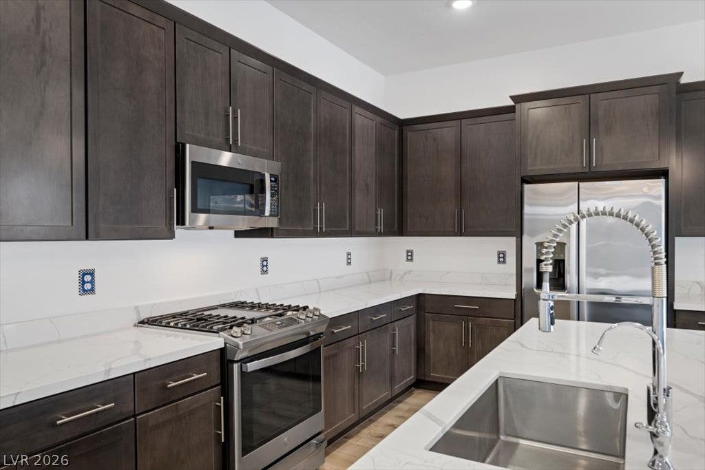 Rich dark cabinetry pairs beautifully with clean stone countertops and professional-grade stainless appliances.