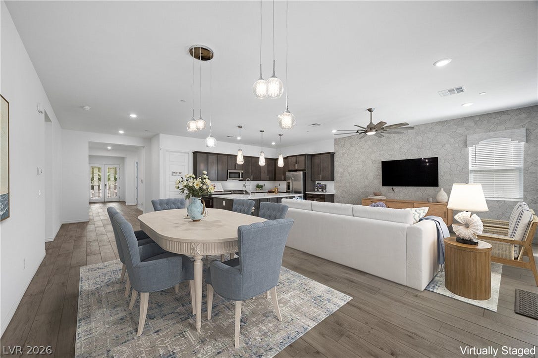 An open concept design seamlessly connects the dining area to the kitchen and living spaces.