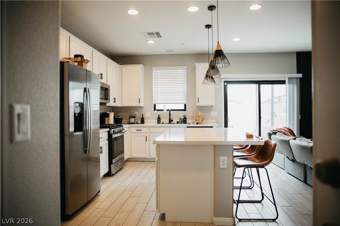6483 Perch Coo Avenue, Las Vegas, NV 89130 Modern cabinetry and recessed lighting define this open concept kitchen design.