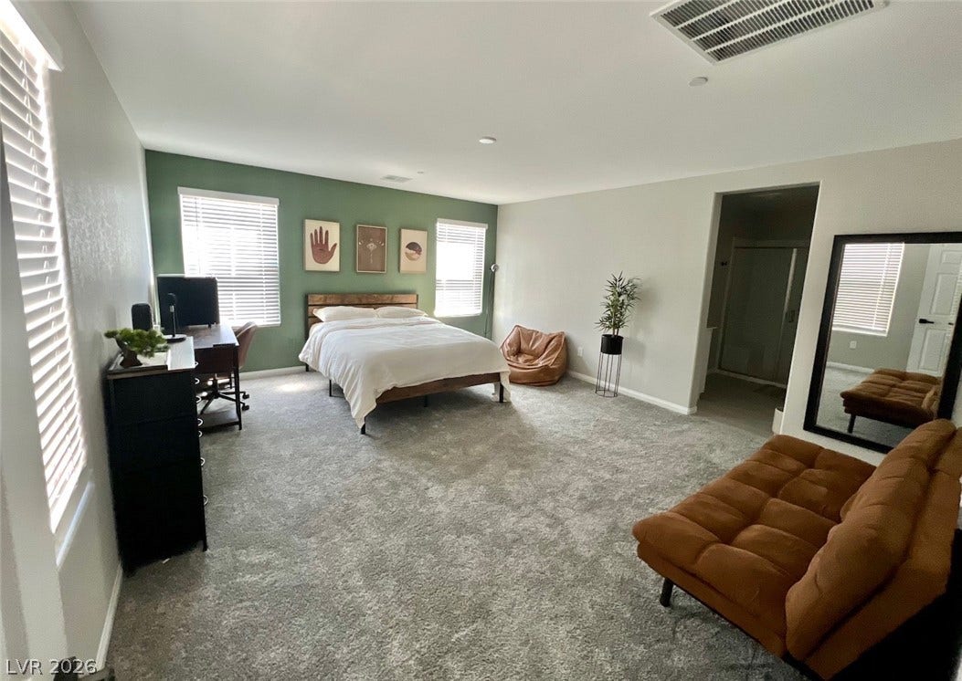 6483 Perch Coo Avenue, Las Vegas, NV 89130 Plentiful natural light fills this spacious bedroom complete with neutral carpeting and an ensuite bath.