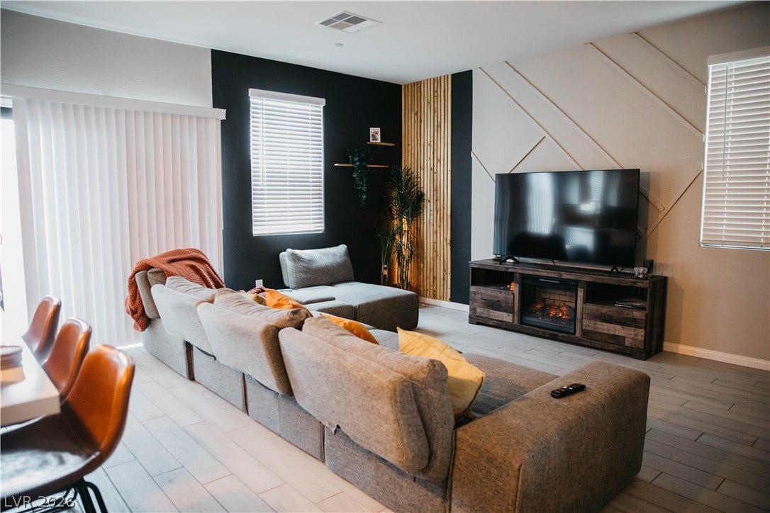 6483 Perch Coo Avenue, Las Vegas, NV 89130 Modern paneled walls and sleek tile flooring define this inviting open living space.