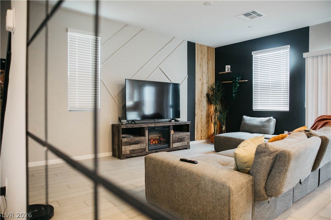 6483 Perch Coo Avenue, Las Vegas, NV 89130 Clean lines and geometric wall detailing define this inviting modern living space.