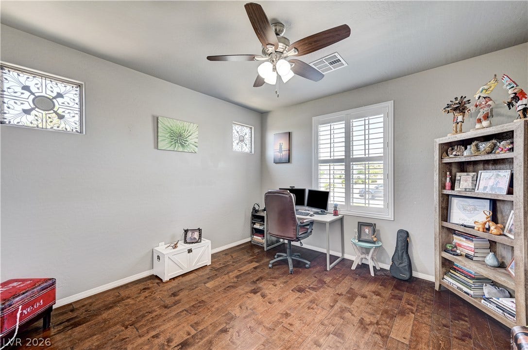 3605 Greenbriar Bluff Avenue, North Las Vegas, NV 89081 Rich hardwood flooring anchors this versatile space illuminated by multi-pane windows.