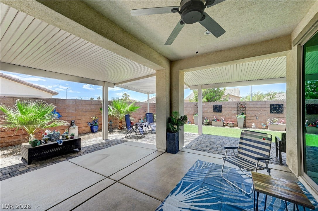 3605 Greenbriar Bluff Avenue, North Las Vegas, NV 89081 A spacious covered patio features clean concrete flooring and transitions seamlessly into the backyard.