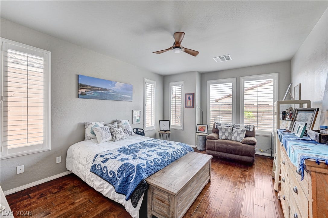 3605 Greenbriar Bluff Avenue, North Las Vegas, NV 89081 Gleaming hardwood floors and classic plantation shutters define this inviting bedroom space.