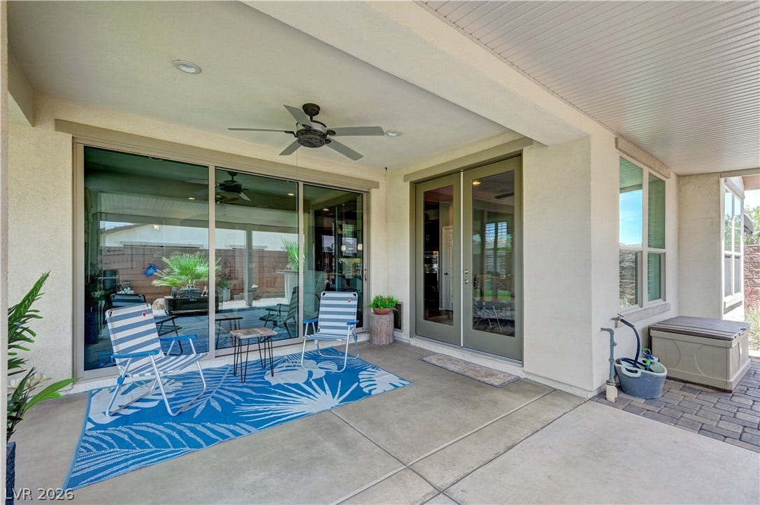 3605 Greenbriar Bluff Avenue, North Las Vegas, NV 89081 A spacious covered patio features clean concrete flooring and smooth access to the interior.