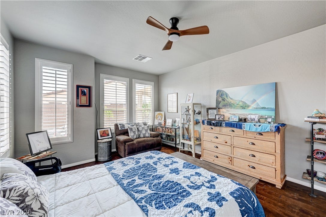 3605 Greenbriar Bluff Avenue, North Las Vegas, NV 89081 Rich hardwood floors and plantation shutters define this inviting bedroom space.