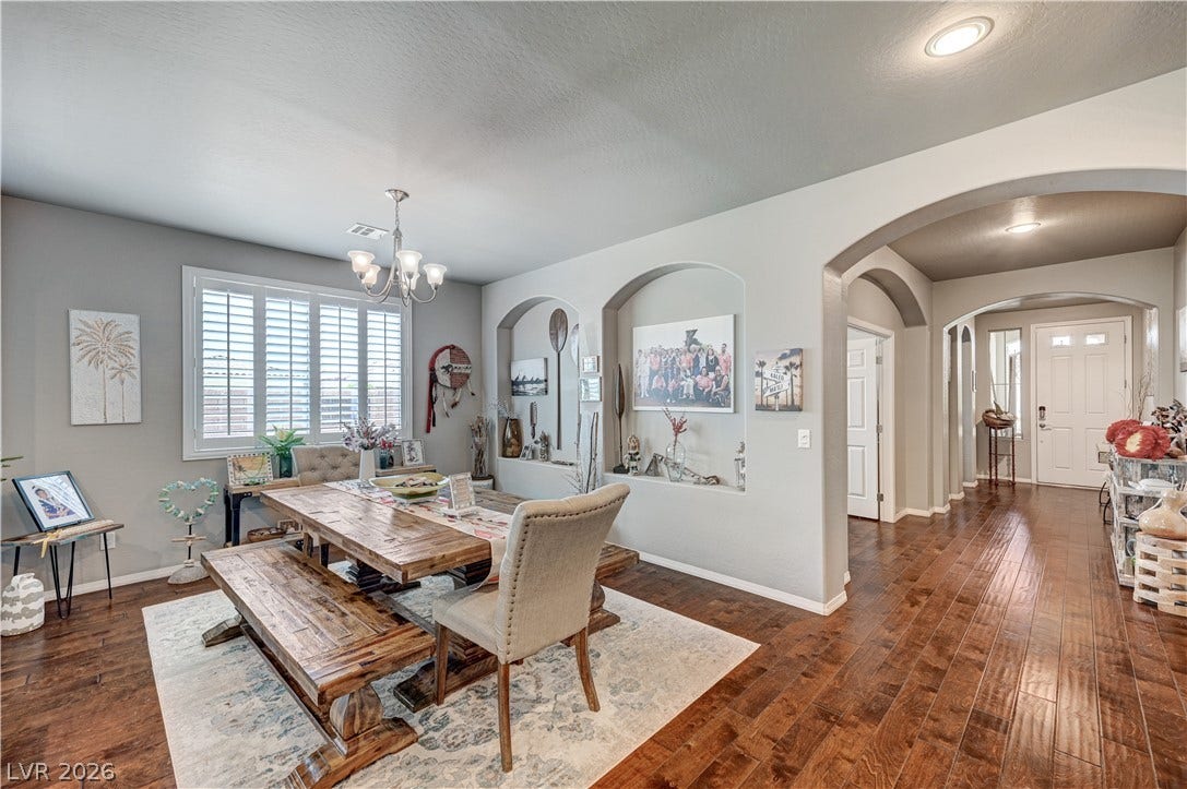 3605 Greenbriar Bluff Avenue, North Las Vegas, NV 89081 Arched doorways and polished hardwood floors lead seamlessly into a light-filled dining space.