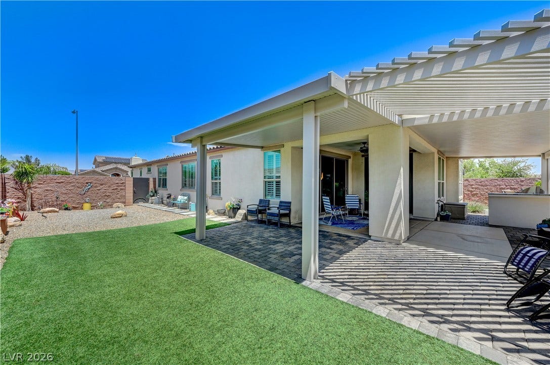 3605 Greenbriar Bluff Avenue, North Las Vegas, NV 89081 An inviting covered patio transitions seamlessly to a beautifully manicured lawn and private yard.
