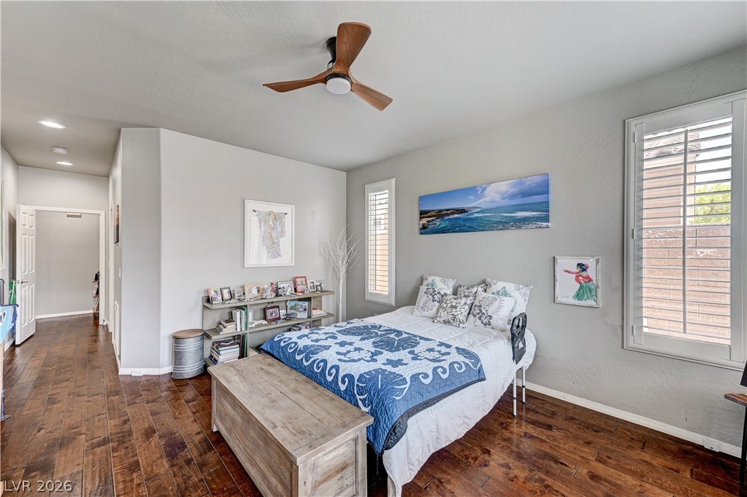 3605 Greenbriar Bluff Avenue, North Las Vegas, NV 89081 Rich hardwood flooring runs throughout this inviting bedroom complete with elegant plantation shutters.