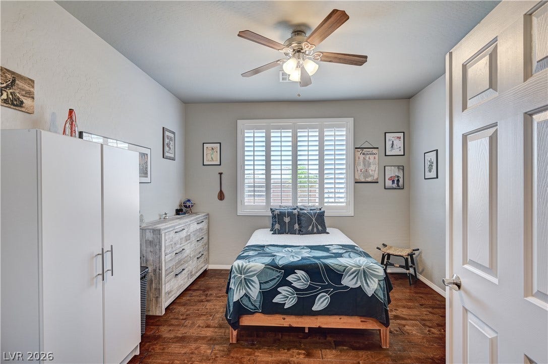3605 Greenbriar Bluff Avenue, North Las Vegas, NV 89081 Rich wood flooring pairs elegantly with plantation shutters in this welcoming bedroom.