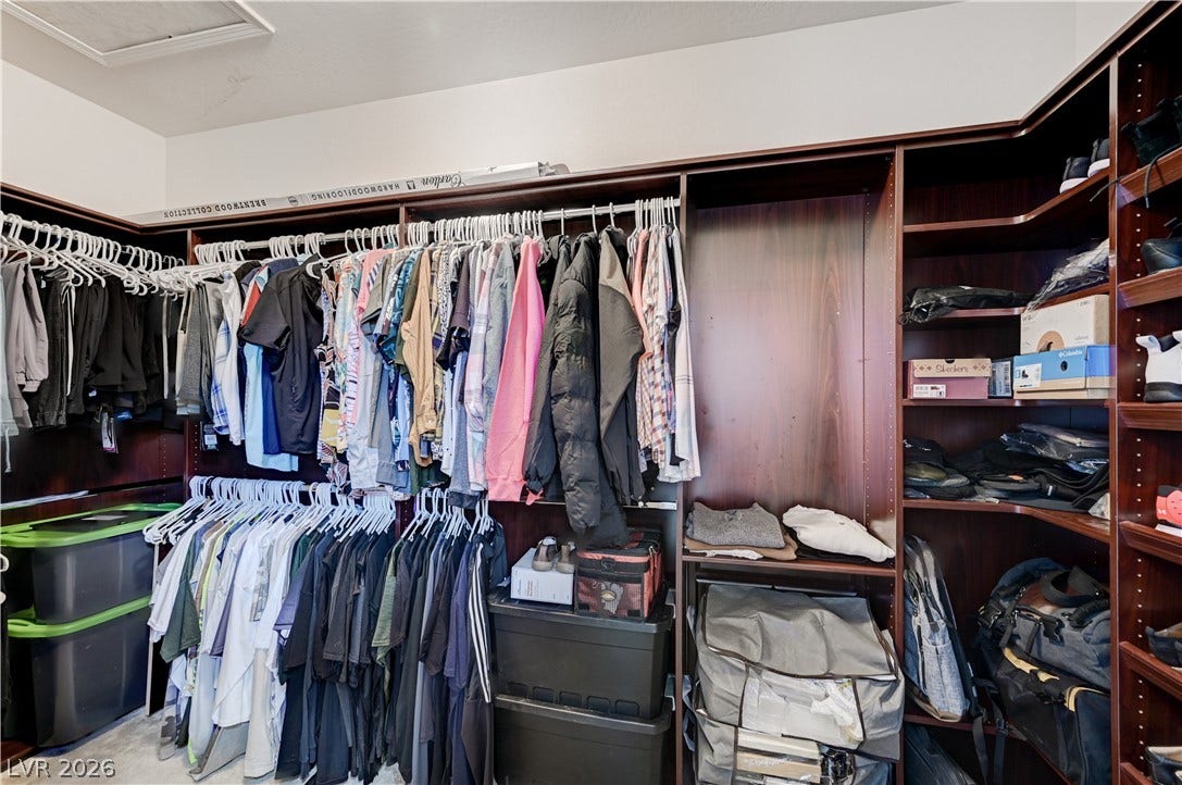 3605 Greenbriar Bluff Avenue, North Las Vegas, NV 89081 Custom dark wood shelving systems maximize storage space in this functional walk-in closet.