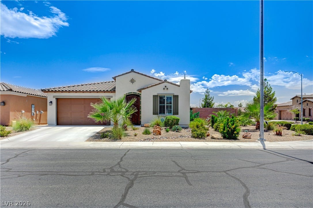 3605 Greenbriar Bluff Avenue, North Las Vegas, NV 89081 Desert landscaping and tile roofing enhance the classic southwestern exterior of this single-story home.
