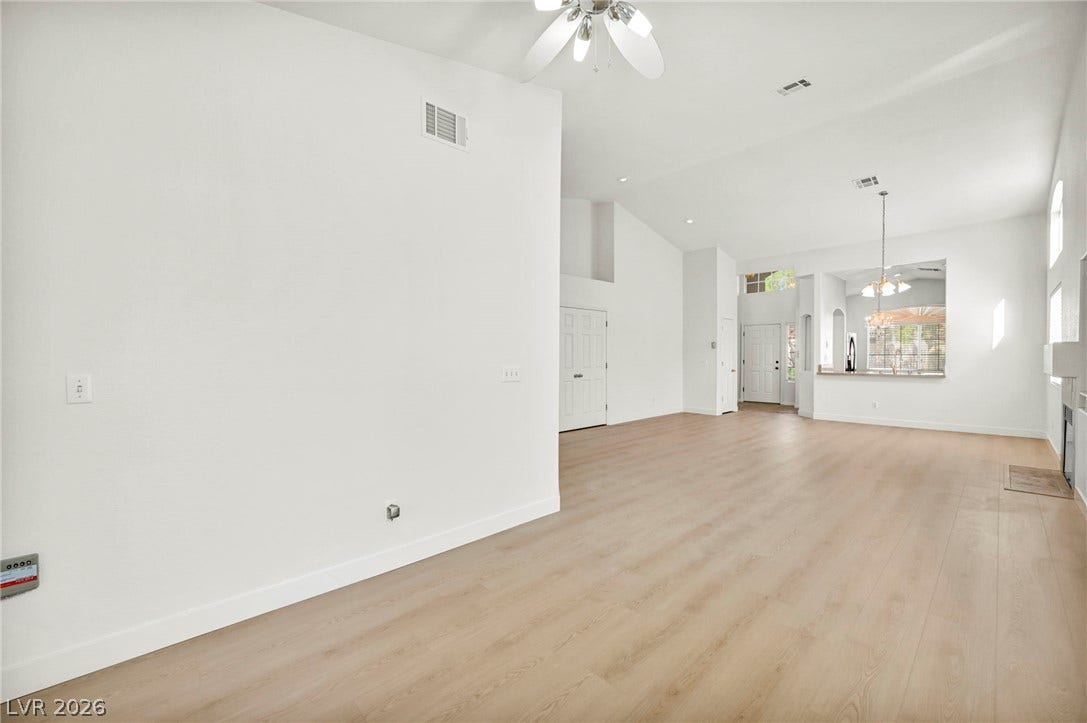 1745 Lily Pond Circle, Henderson, NV 89012 Crisp white walls complement clean plank flooring throughout this airy open layout.