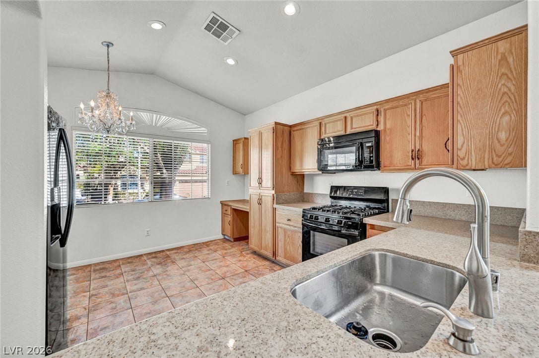 1745 Lily Pond Circle, Henderson, NV 89012 Vaulted ceilings and warm tile flooring elevate this functional culinary space.