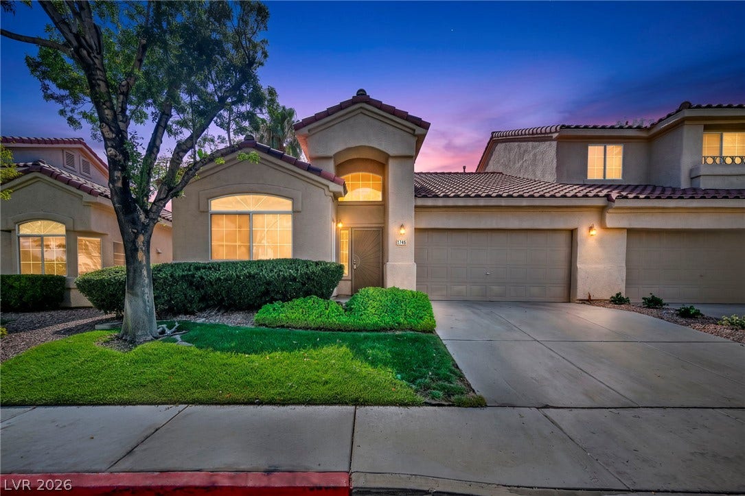 1745 Lily Pond Circle, Henderson, NV 89012 A stucco exterior with a tiled roof and an attached garage defines this contemporary residence.
