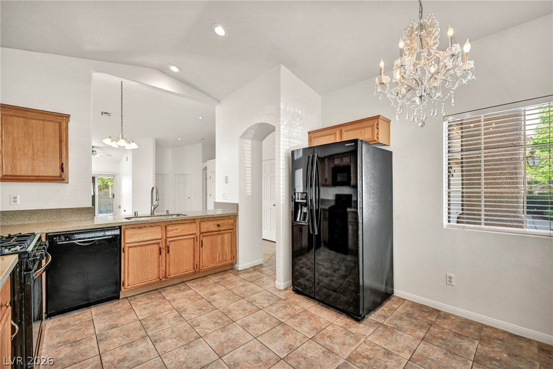 1745 Lily Pond Circle, Henderson, NV 89012 An elegant chandelier highlights the transition from tile floors to vaulted ceilings in this kitchen.