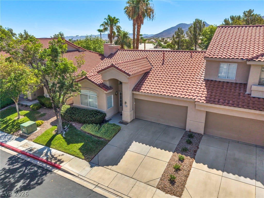 1745 Lily Pond Circle, Henderson, NV 89012 Clay tile roofing and a spacious concrete driveway define this modern desert exterior.