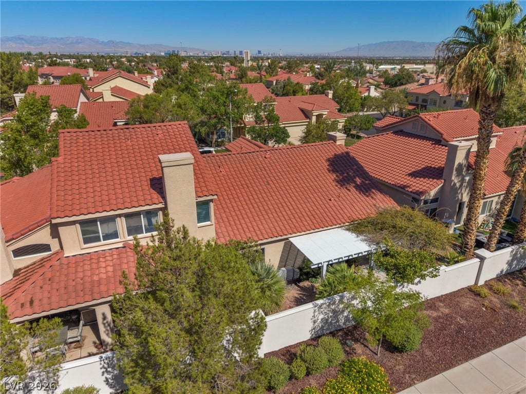 1745 Lily Pond Circle, Henderson, NV 89012 Tiled roofs and desert landscaping define this neighborhood overlooking a distant city skyline.
