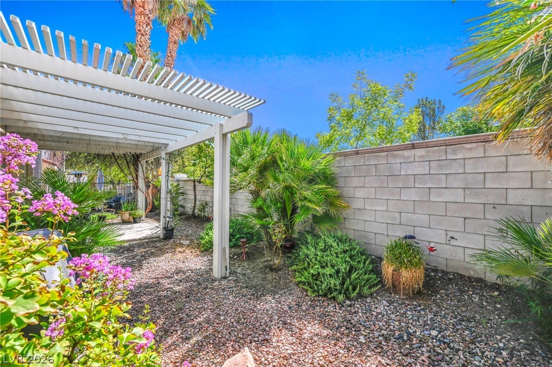 1745 Lily Pond Circle, Henderson, NV 89012 Mature plantings and a classic pergola define this private gravel courtyard.