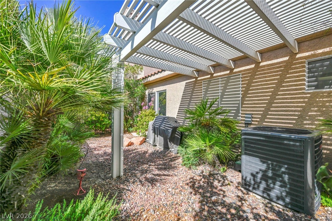 1745 Lily Pond Circle, Henderson, NV 89012 Lush tropical plantings flank a spacious side yard shaded by a classic overhead pergola.