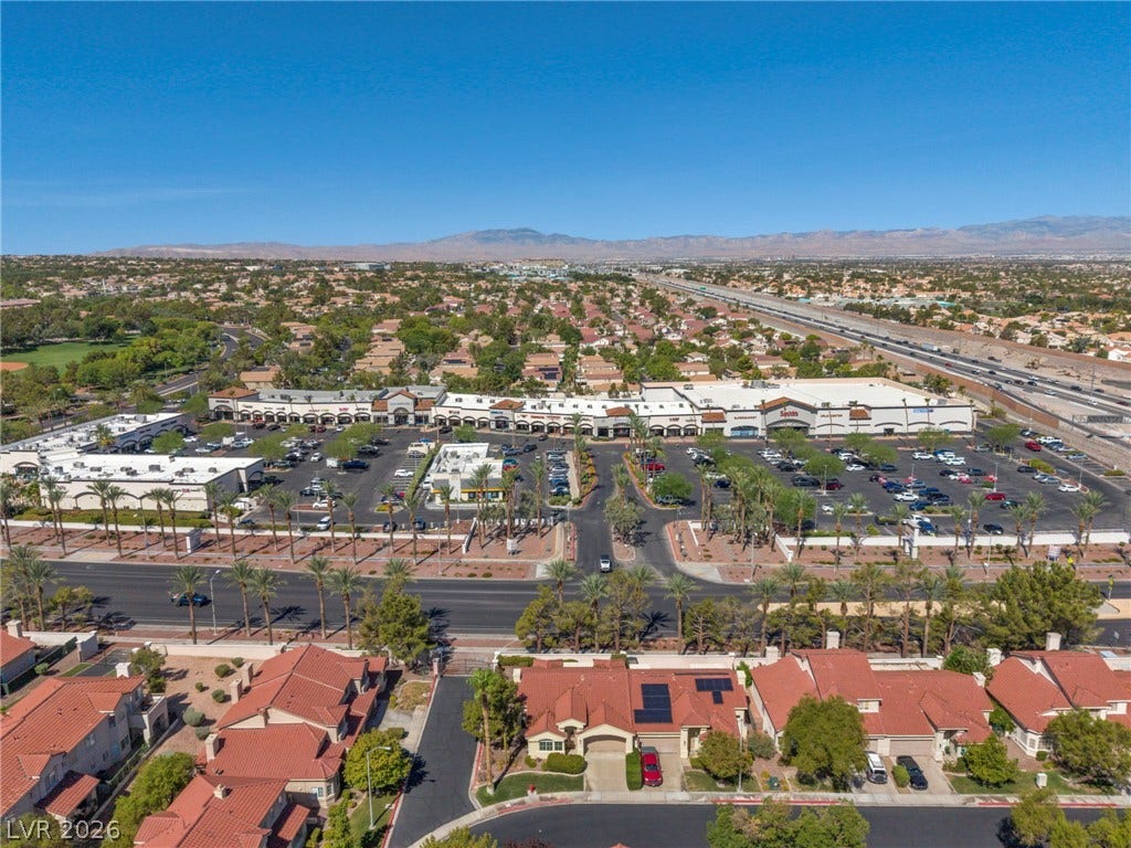 1745 Lily Pond Circle, Henderson, NV 89012 Distant mountains frame a sprawling neighborhood perspective under a clear blue sky.