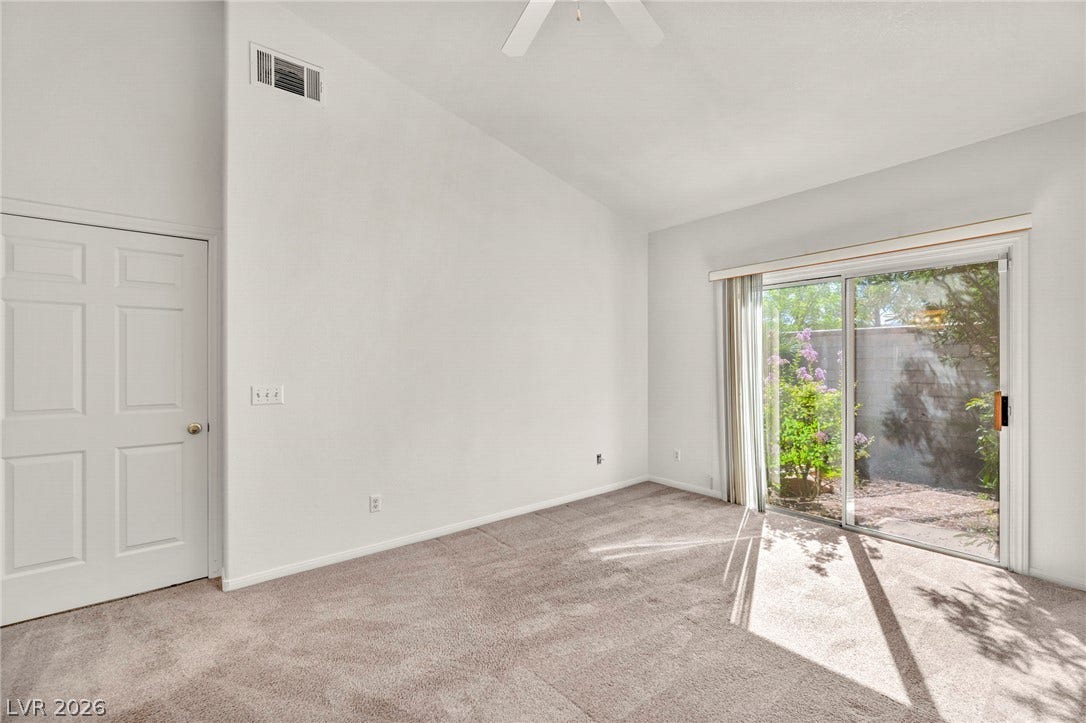 1745 Lily Pond Circle, Henderson, NV 89012 Sliding glass doors open directly to the patio from this carpeted bedroom.