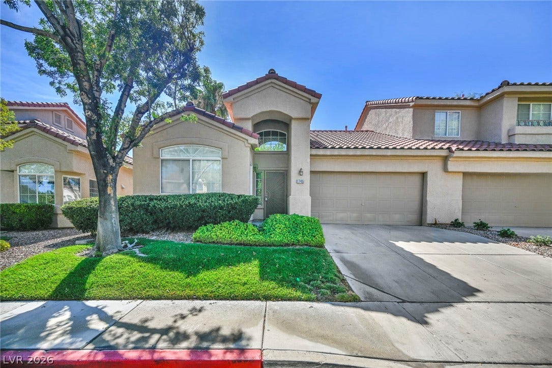 1745 Lily Pond Circle, Henderson, NV 89012 Spanish tile roofing and structured stucco walls define this classic suburban exterior.