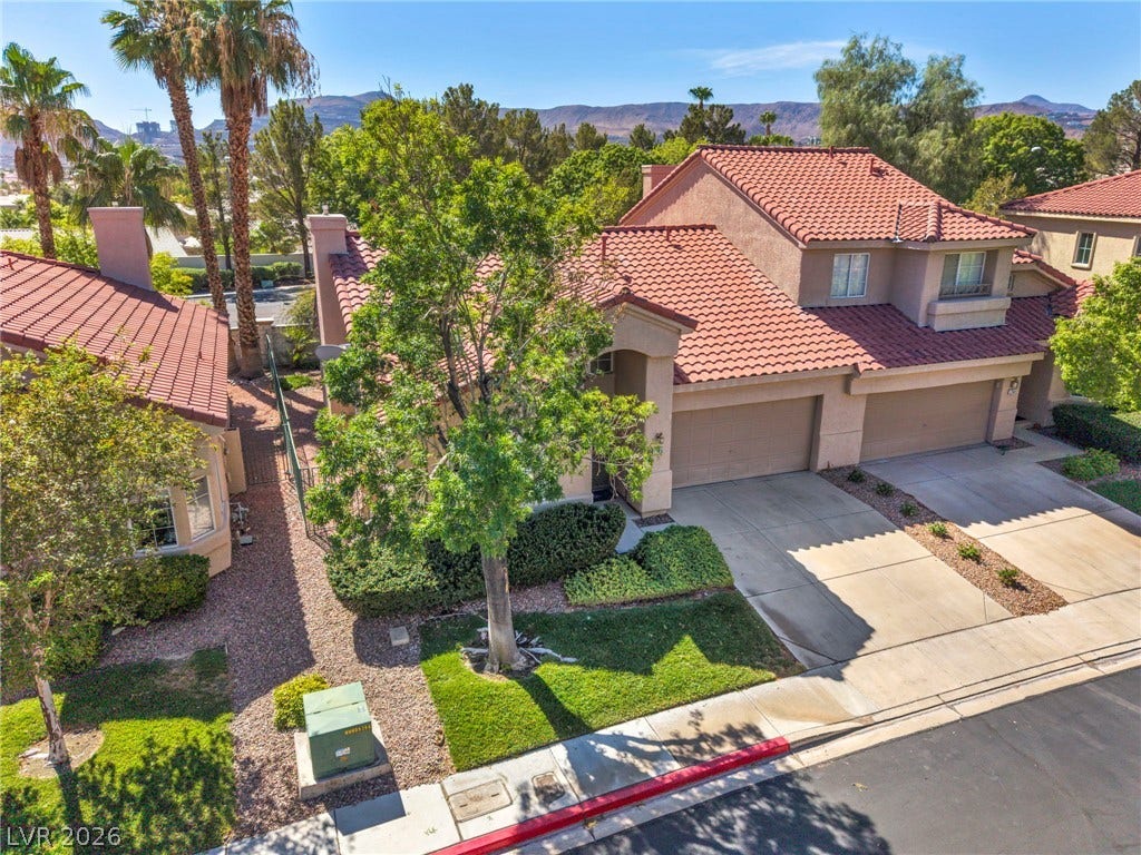 1745 Lily Pond Circle, Henderson, NV 89012 Spanish tile roofs and private driveways frame this classic multi-level desert neighborhood home.