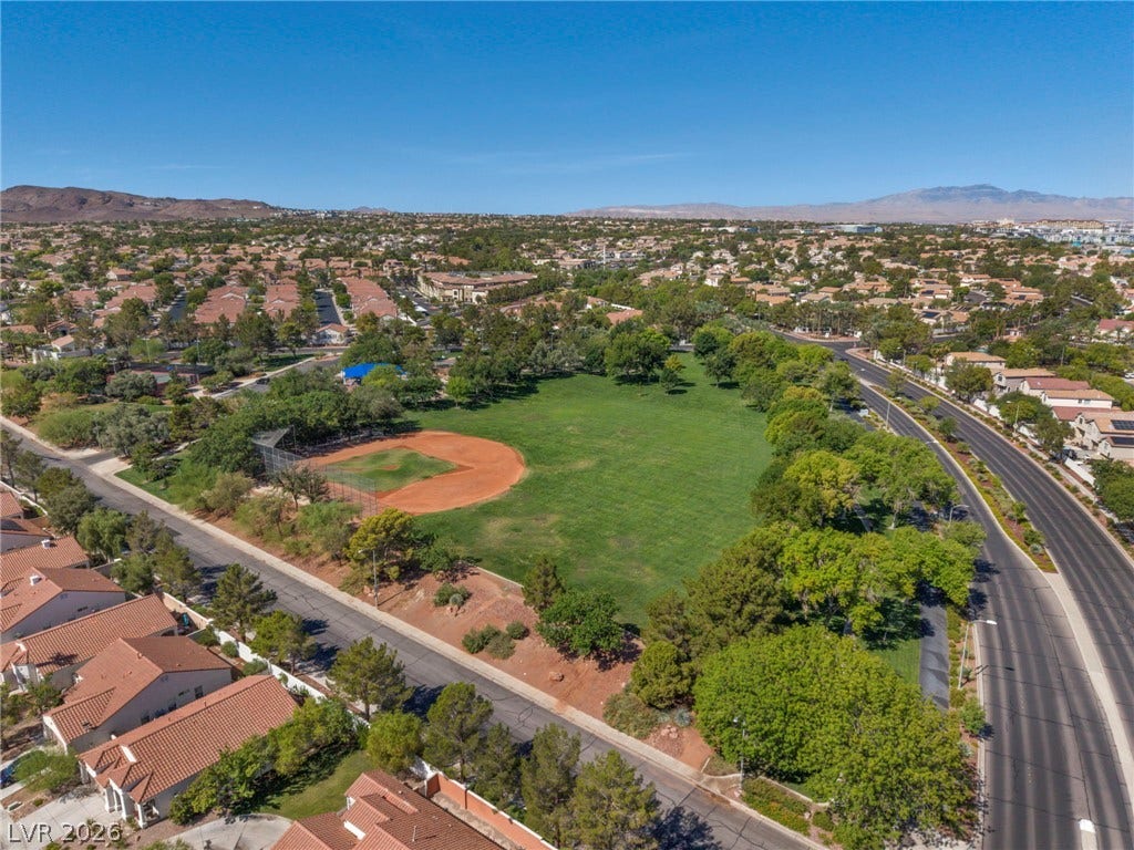 1745 Lily Pond Circle, Henderson, NV 89012 A spacious community park sits nestled within a quiet residential neighborhood under clear blue skies.