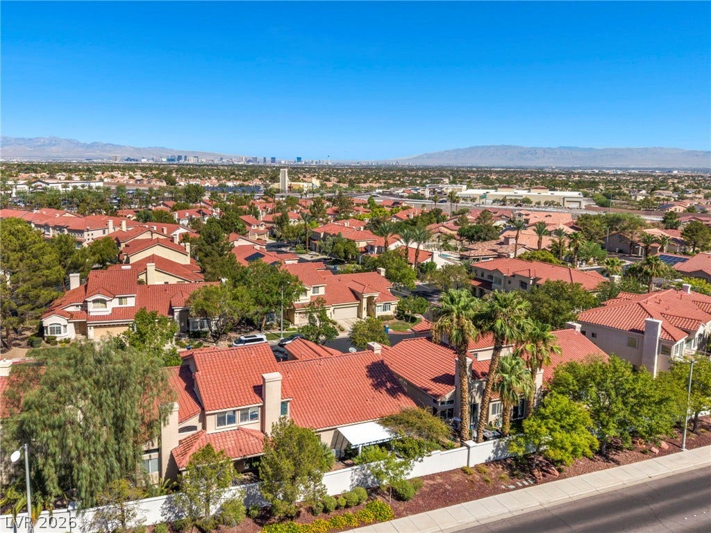 1745 Lily Pond Circle, Henderson, NV 89012 Distant city skyline and mountain views elevate this charming neighborhood setting with tile roofs.