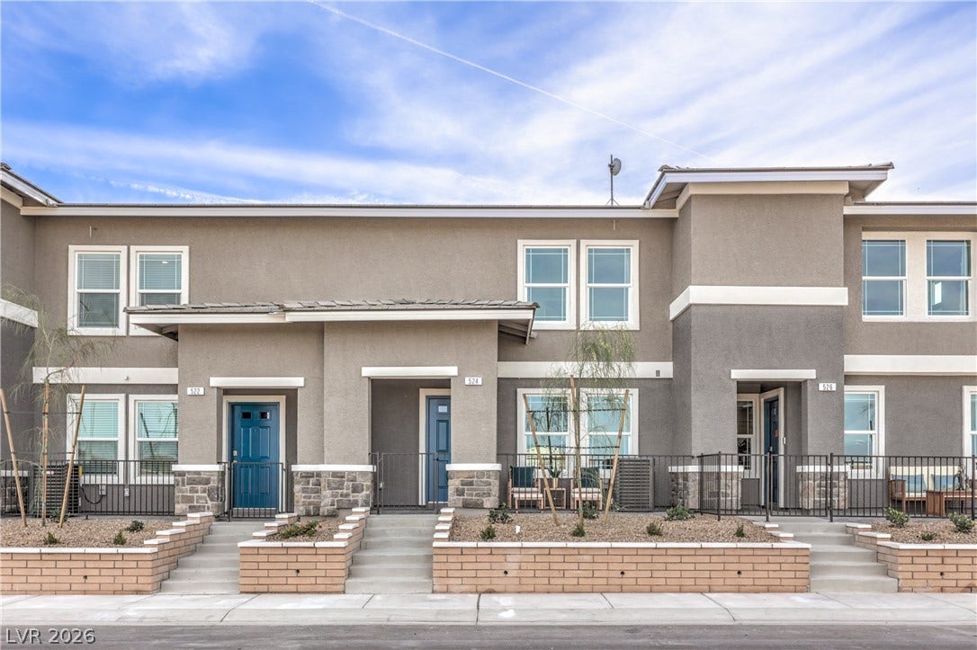 Clean lines and stone accents define this modern multi-level exterior facade.