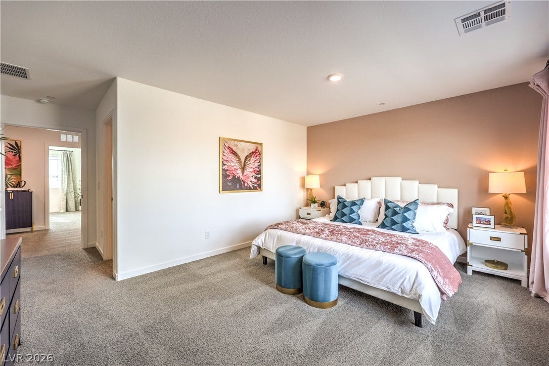 Plush wall-to-wall carpeting and smooth plaster finishes define this comfortable primary suite.