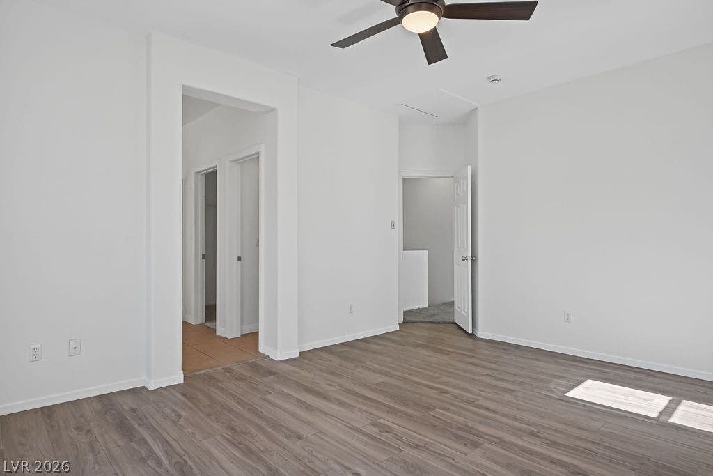 754 Solitude Point Avenue, Henderson, NV 89012 Gleaming wood flooring complements the neutral palette of this modern bedroom layout.