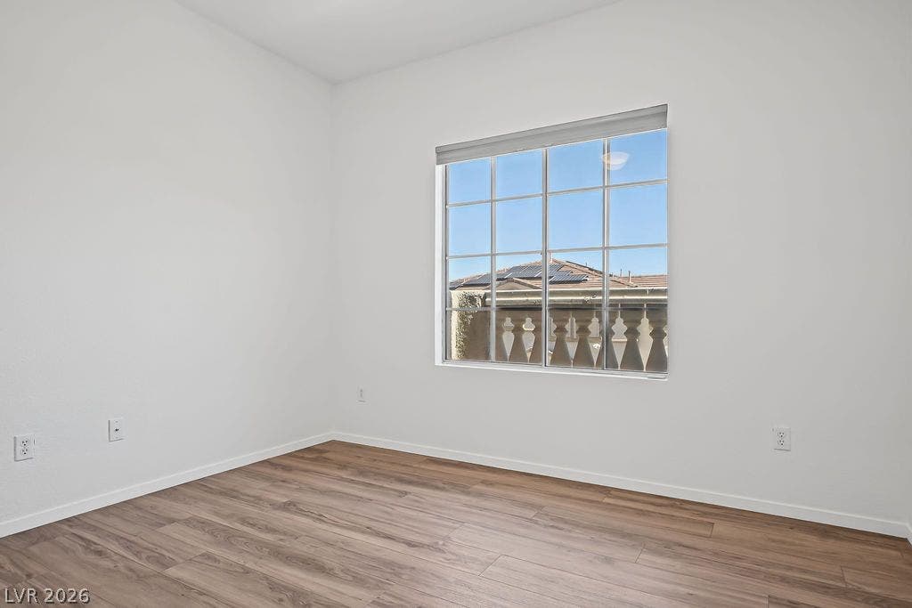 754 Solitude Point Avenue, Henderson, NV 89012 Rich wood-inspired flooring pairs with a large multi-lite window in this versatile space.