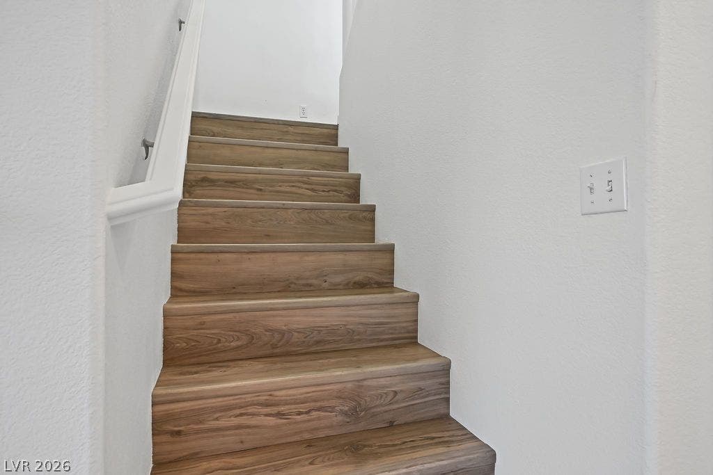 754 Solitude Point Avenue, Henderson, NV 89012 Rich wood treads and crisp white walls elevate this straightforward staircase design.