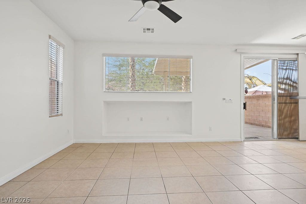 754 Solitude Point Avenue, Henderson, NV 89012 Tiled flooring and a built-in wall niche define this versatile living space.