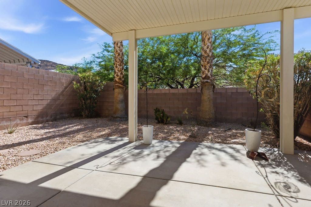754 Solitude Point Avenue, Henderson, NV 89012 An inviting covered patio looks out onto a low-maintenance gravel yard enclosed by block walls.