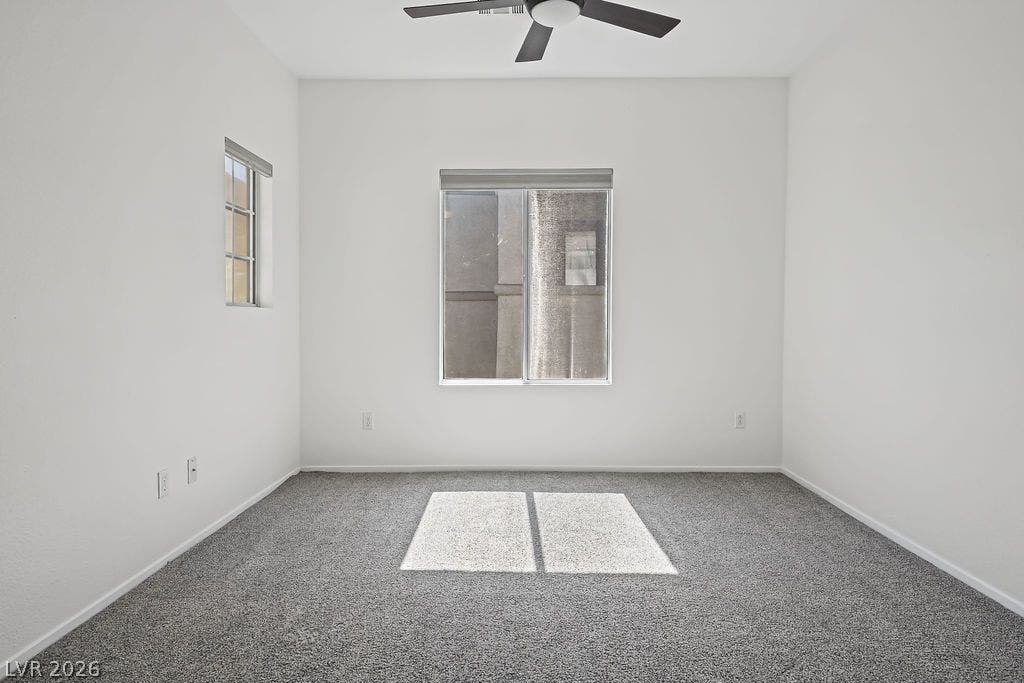 754 Solitude Point Avenue, Henderson, NV 89012 Plentiful natural light streams across the carpeted floor of this versatile bedroom space.