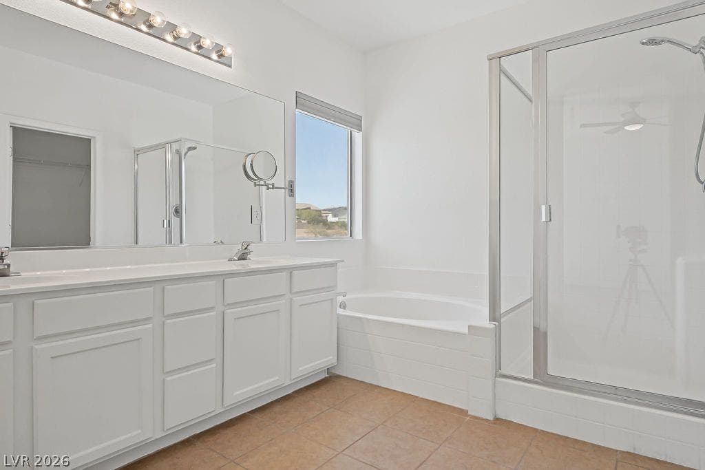 754 Solitude Point Avenue, Henderson, NV 89012 Tiled flooring and a separate glass-enclosed shower complement this functional master bath layout.