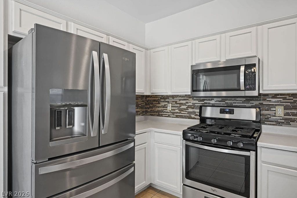 754 Solitude Point Avenue, Henderson, NV 89012 Ample cabinetry and stone countertops frame this well-appointed culinary workspace.
