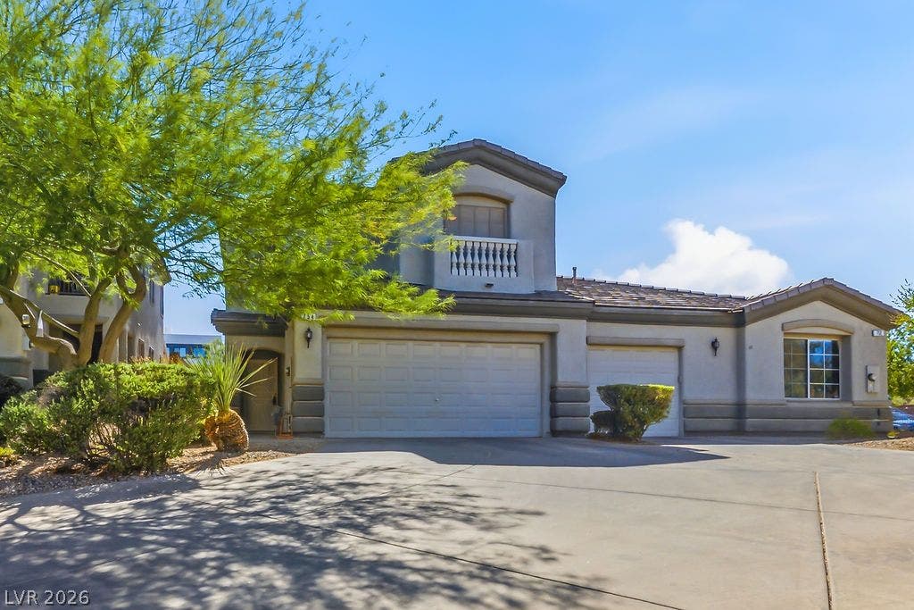754 Solitude Point Avenue, Henderson, NV 89012 Stucco finishes and multi-level rooflines define this modern desert residence with extensive driveway parking.